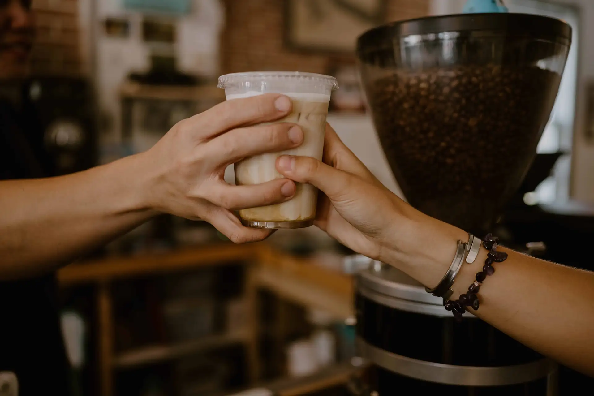 Two hands holding a cup of tea