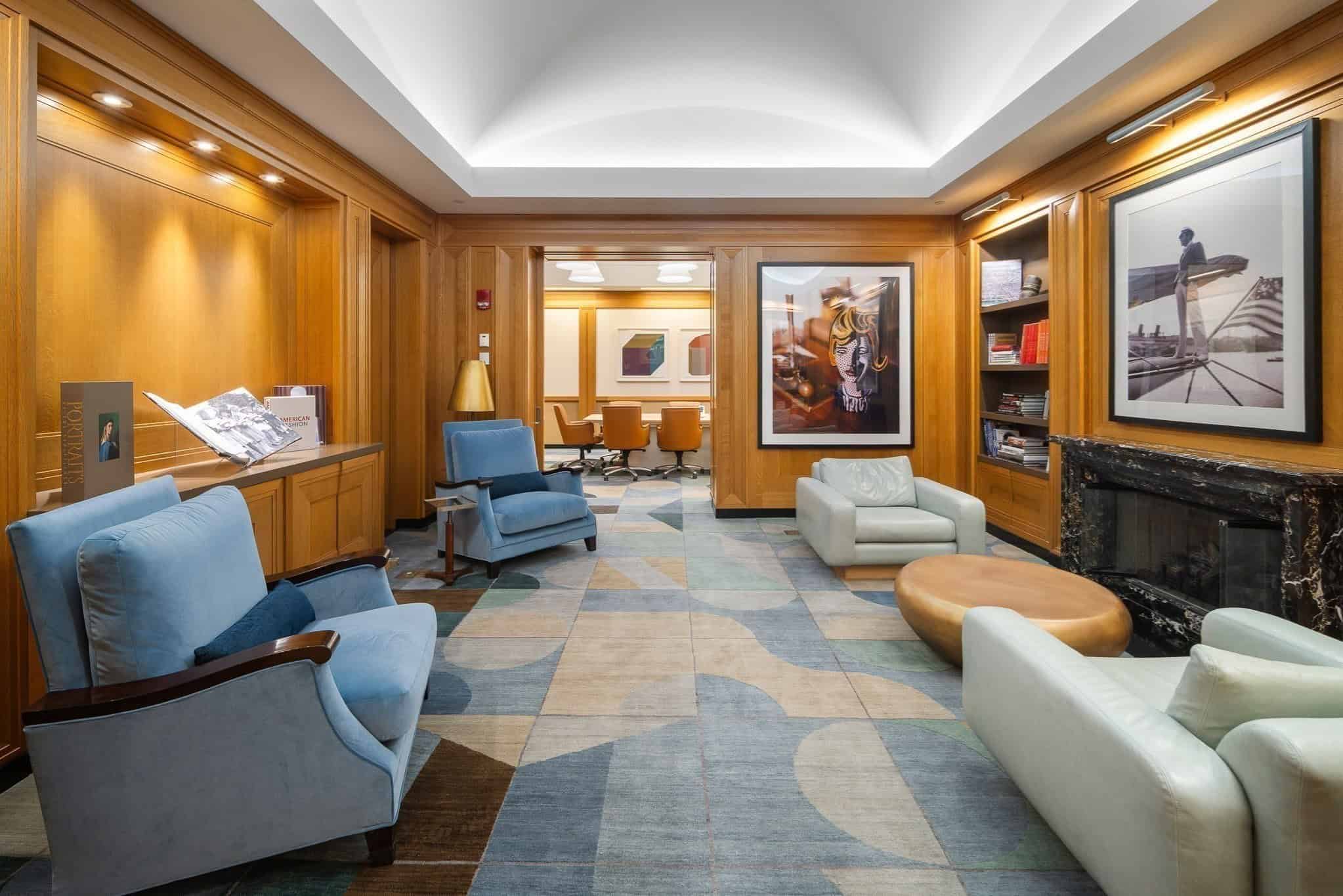Resident lounge with armchairs, artwork and reading table