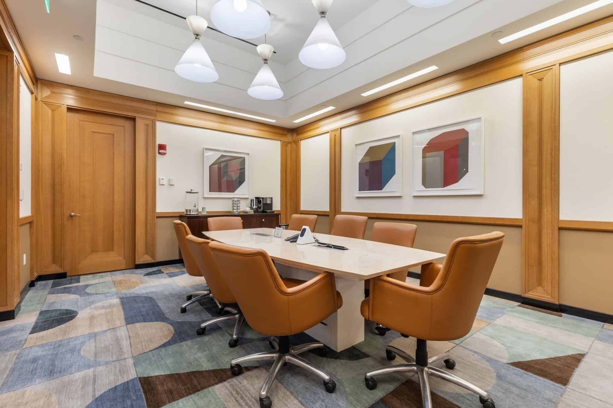 Private conference room with stone table and leather chairs