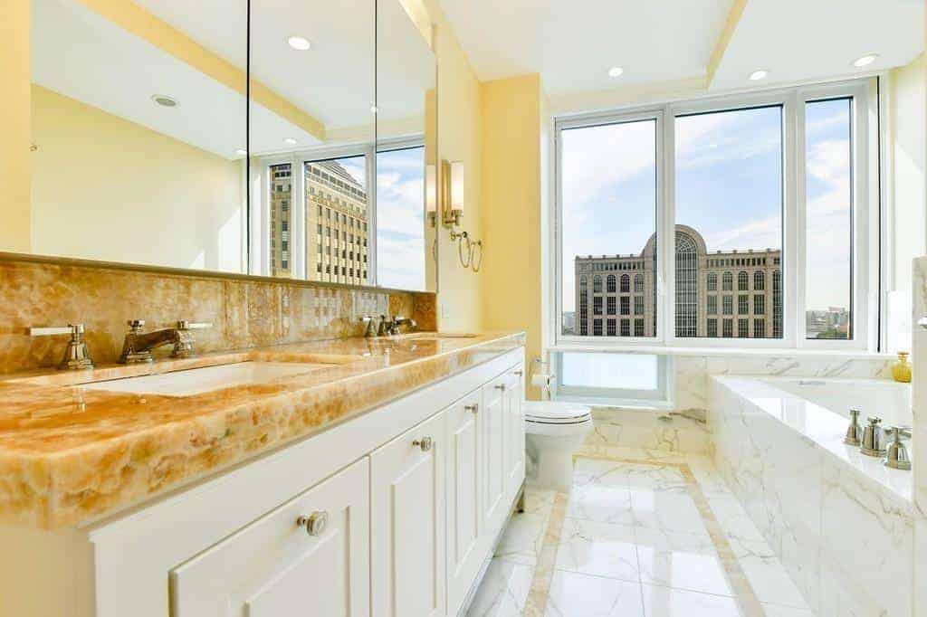 Marble bathroom with soaking tub and city views
