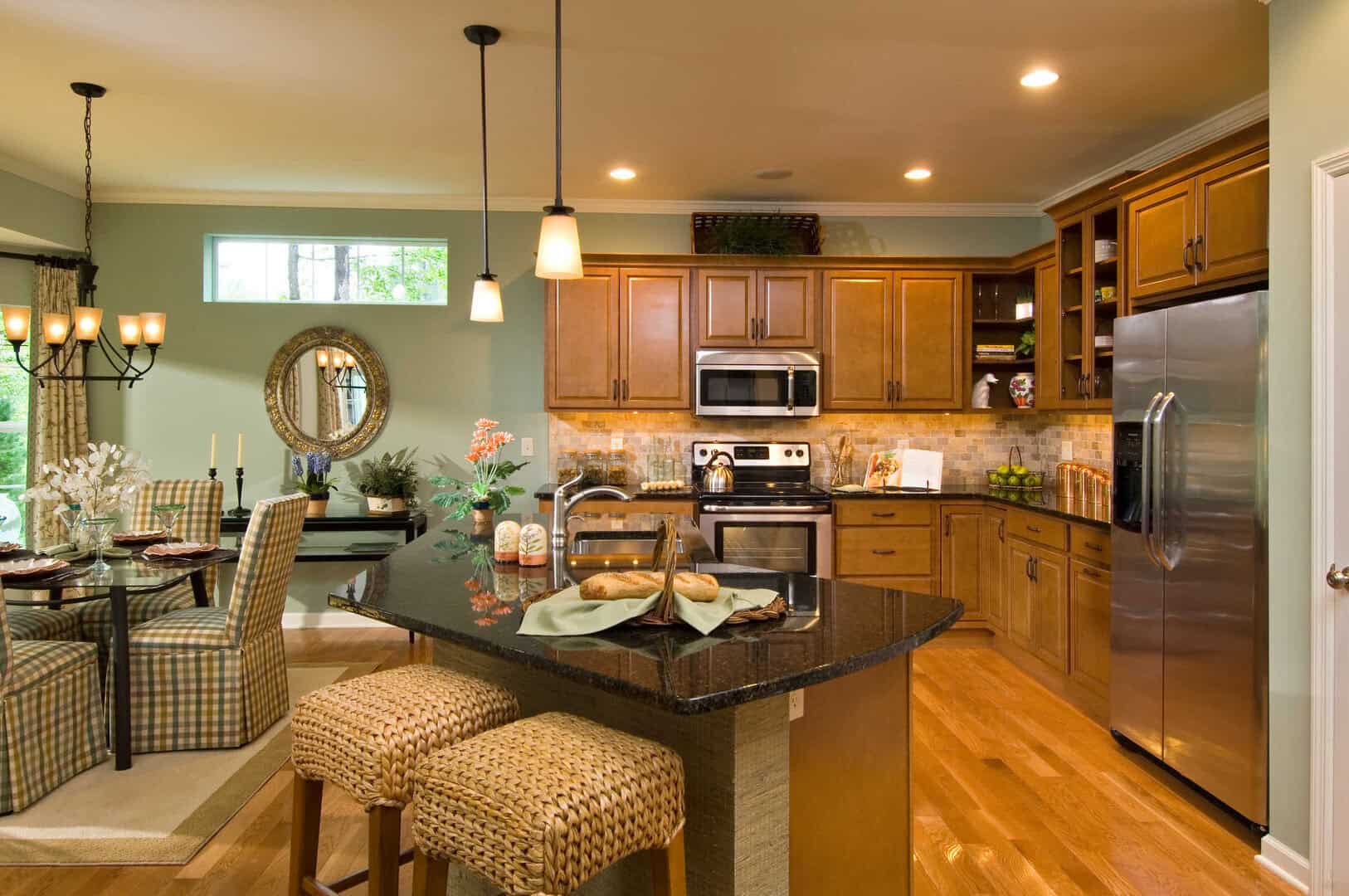 Kitchen with Maple Cabinets, Granite Counters, Hardwood Flooring, and Island that is open to the Dining Area.
