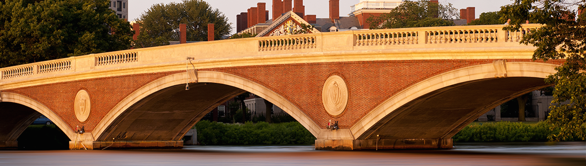 Brick and stone bridge over river with arches