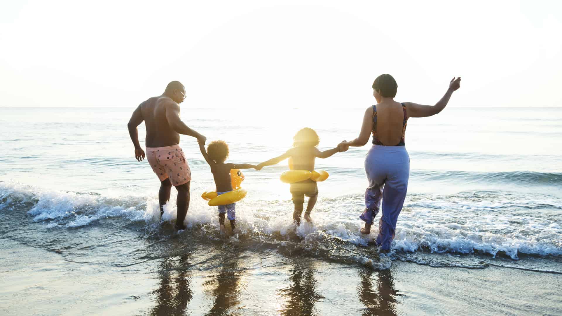 Happy family with kids on the beach