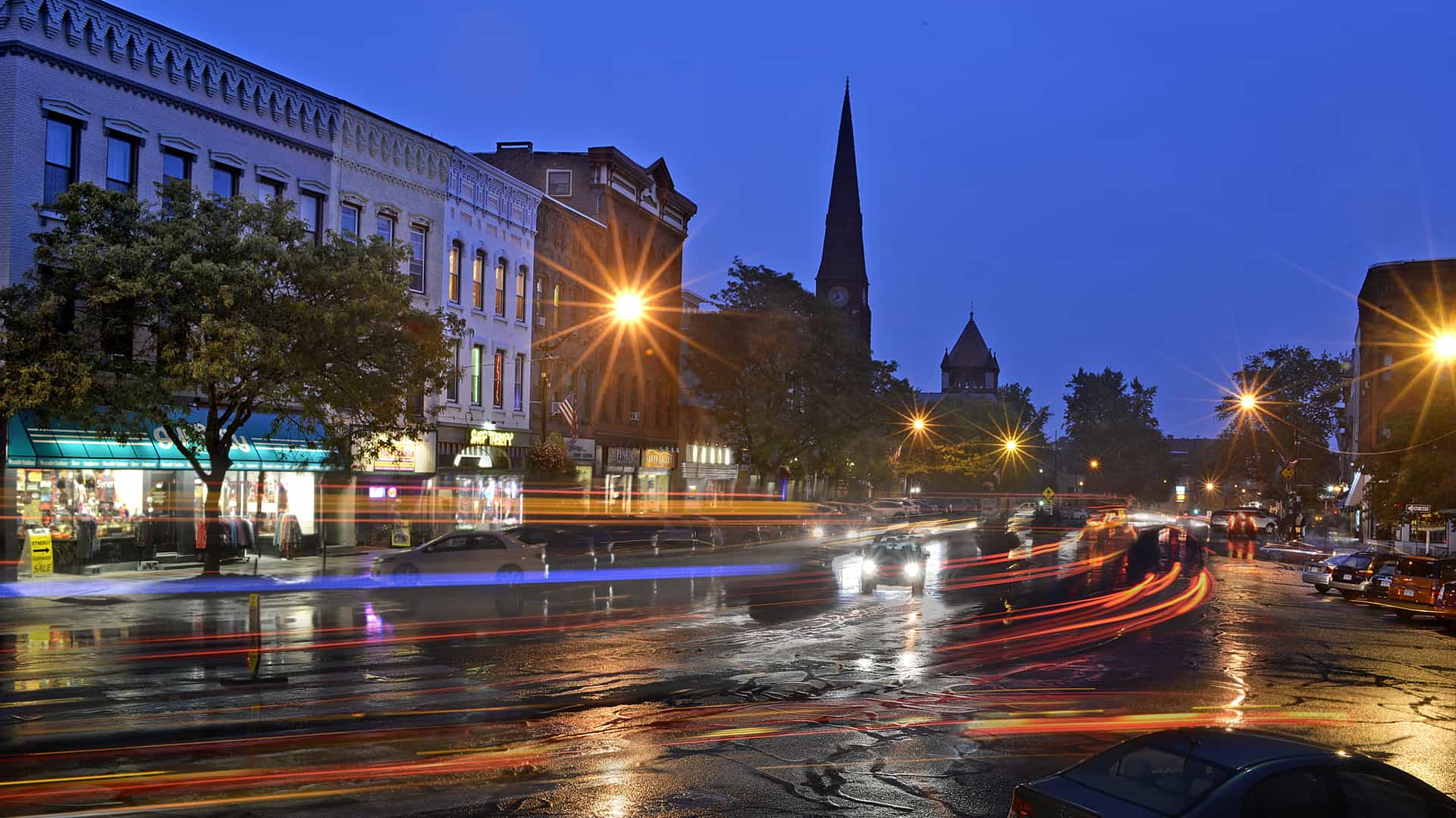 headlights and tailights around city corner at night