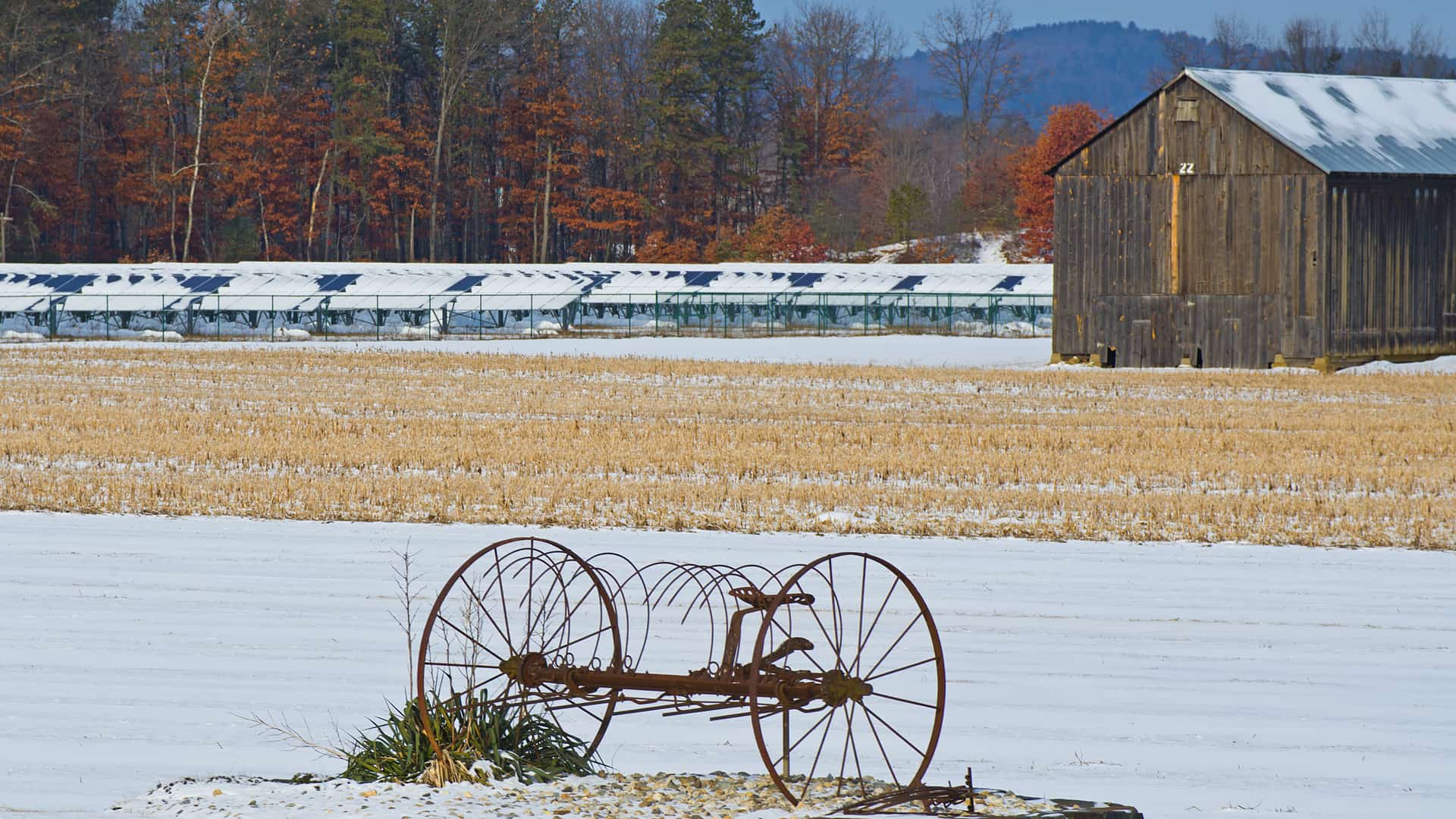 farm field in winter with rusty plow