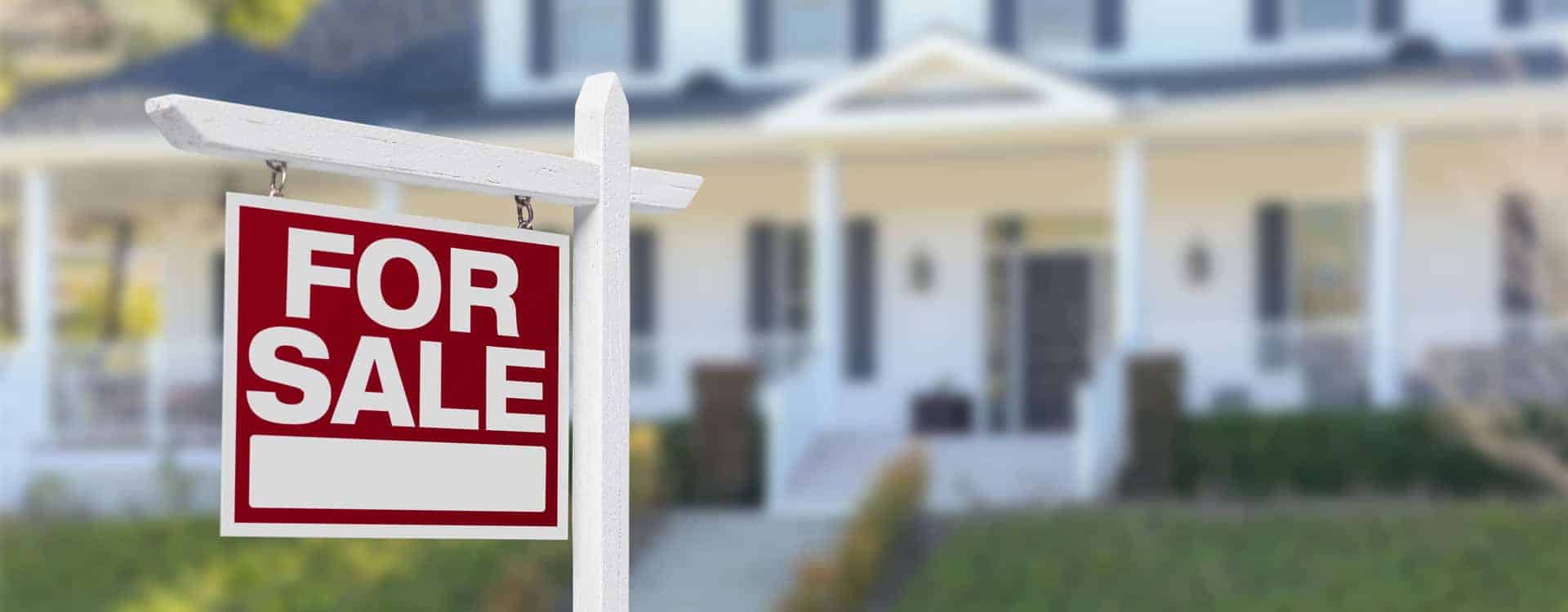 for sale sign in front of house
