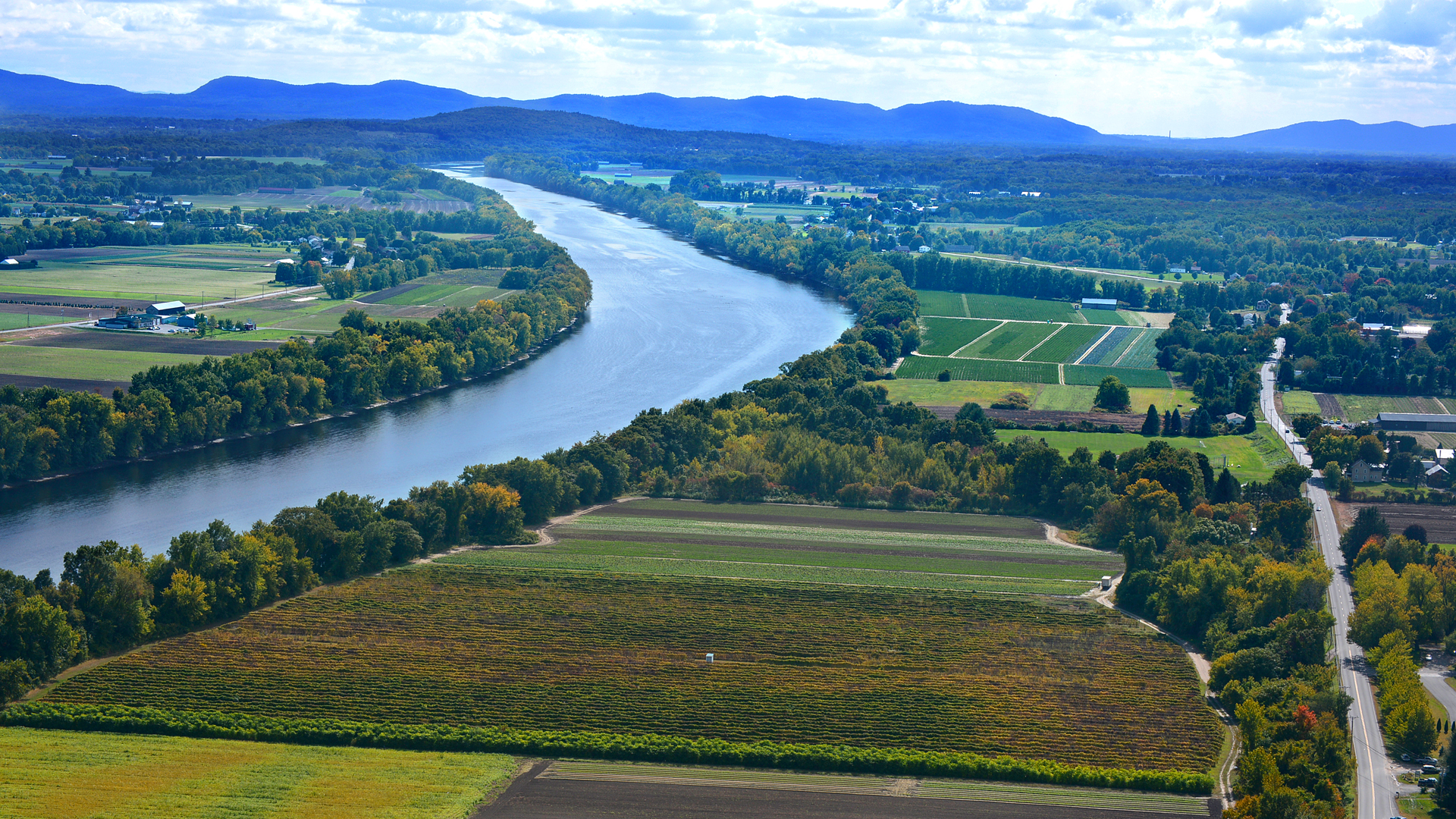 arial view of winding river through farm fields