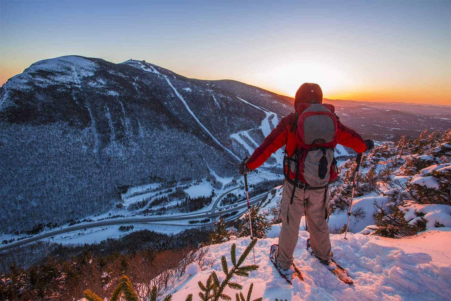 A skier stands on a snow-capped mountain