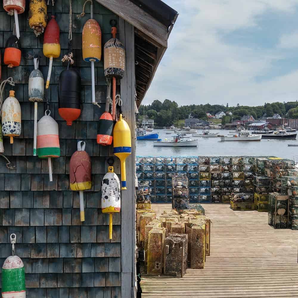 old buoys hanging from wall on dock.