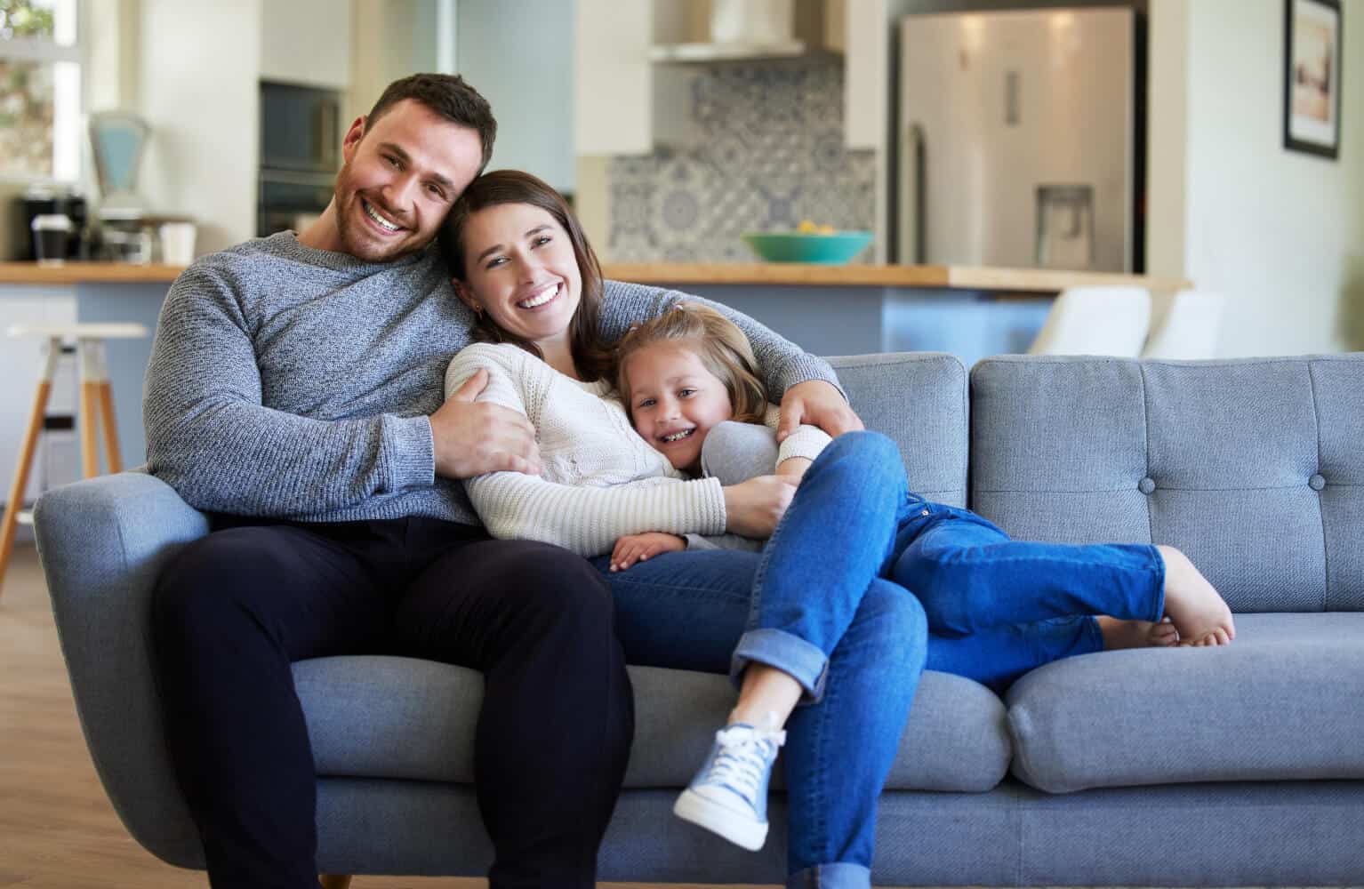 young family relaxing on the couch at home